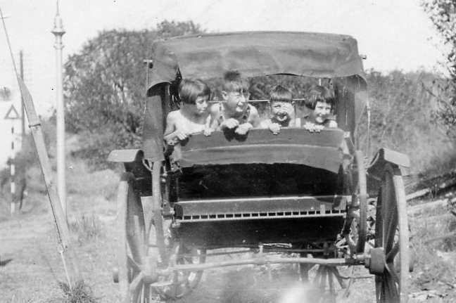 Margaret  with brothers and sister in a buggy while on holiday